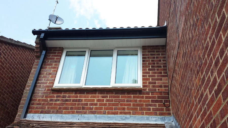 Black Ash fascia with White tongue and groove soffit and Black square guttering in Romsey, Hampshire