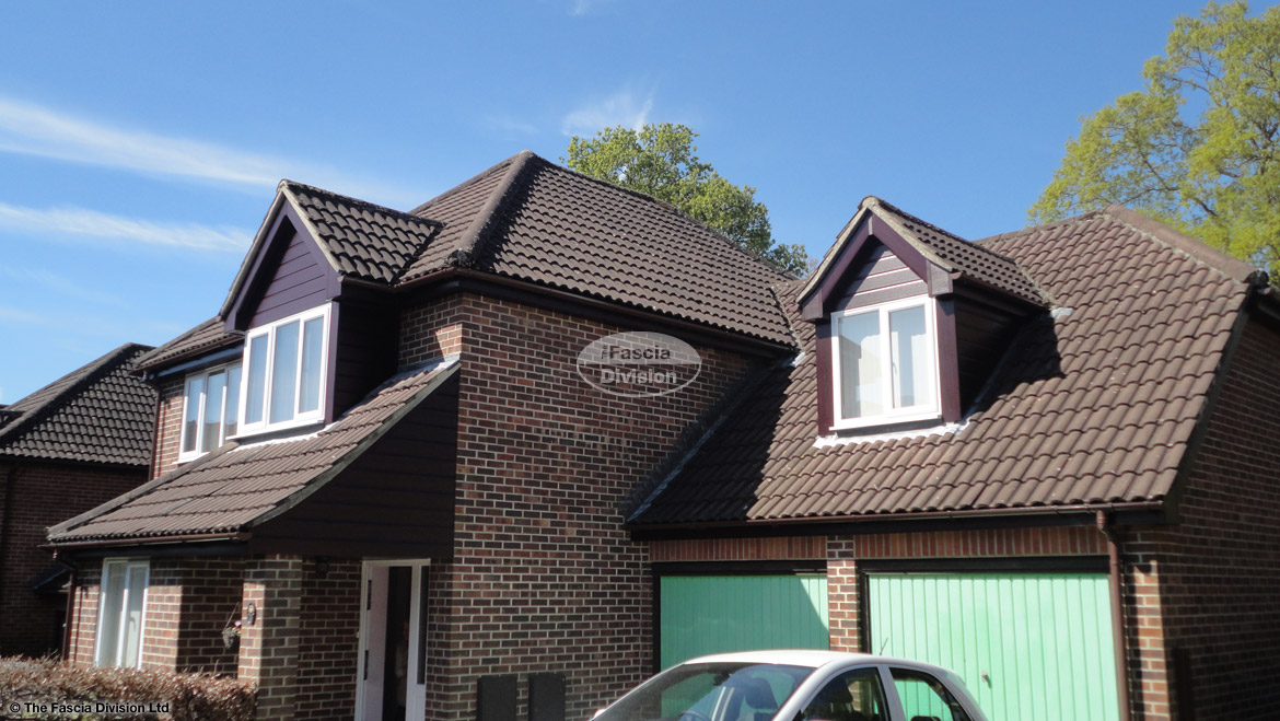Installation of new rosewood UPVC shiplap cladding, fascias and soffits with UPVC brown guttering