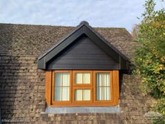 Black Hardieplank weatherboard, black fascia and guttering photo