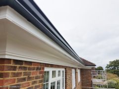 white flat soffit with continuous guttering in black