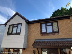 composite cladding installation with rosewood fascia