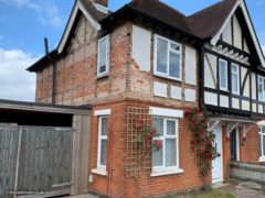 Semi-detached house with old mock tudor boards and render removed