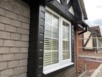 black upvc cladding around a dormer window