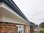 White fascias and soffits with black seamless guttering