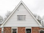 Roof apex with white cladding and white fascia, soffit and guttering