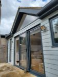 Anthracite fascia, soffits and guttering with Hardieplank cladding
