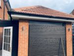 White fascia and soffit with black guttering on a garage
