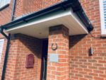 White fascia and soffit with black guttering on a porch