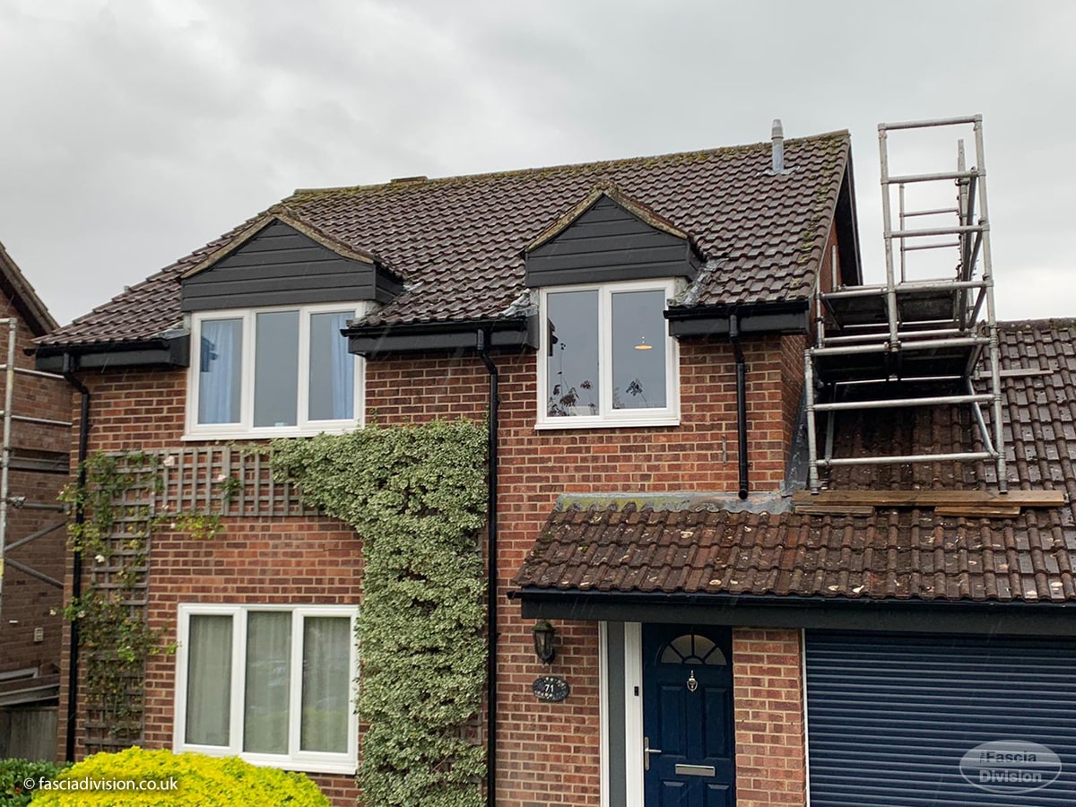 Black fascia, soffits and guttering installation on a detached house