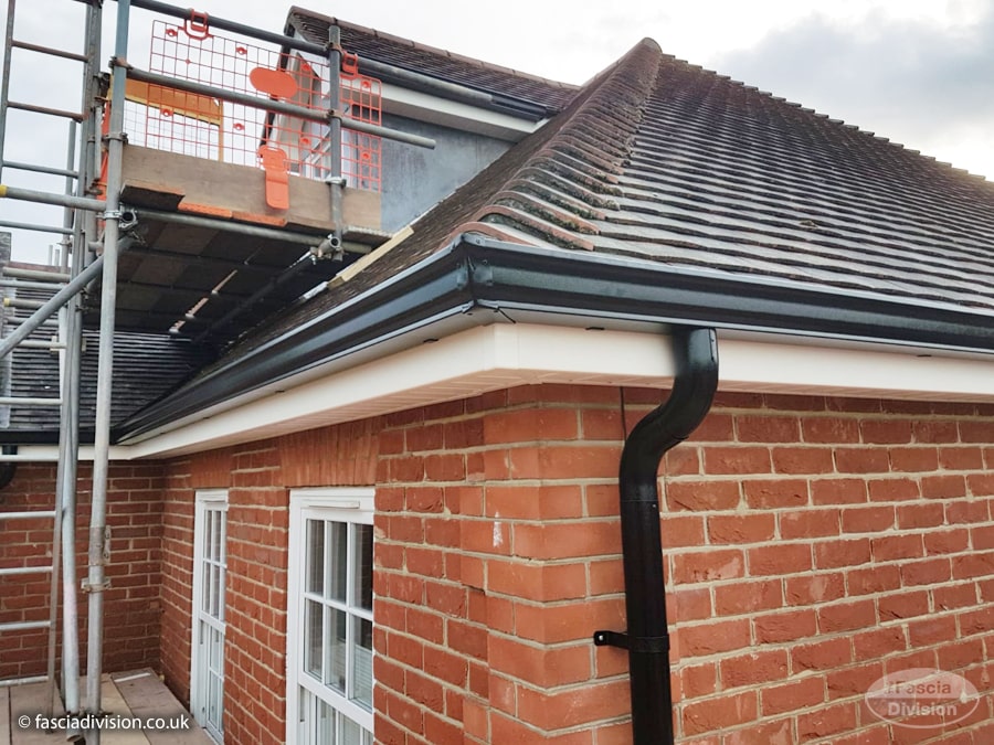 White fascias and soffits with black seamless guttering