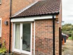 white fascias and soffits with black round guttering