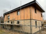 Durasid Foresta cladding installed vertically with anthracite fascias and soffits