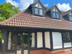 After installation, black mock Tudor and black fascias, soffits and guttering