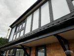 Black mock Tudor with black fascia and white soffit