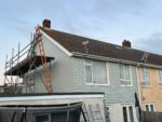 Soft green Hardie Plank cladding on semi-detached house