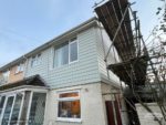 Soft green Hardie Plank cladding on semi-detached house