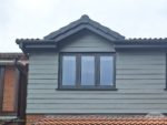 Slate Grey Hardie Plank cladding, anthracite windows on a dormer window